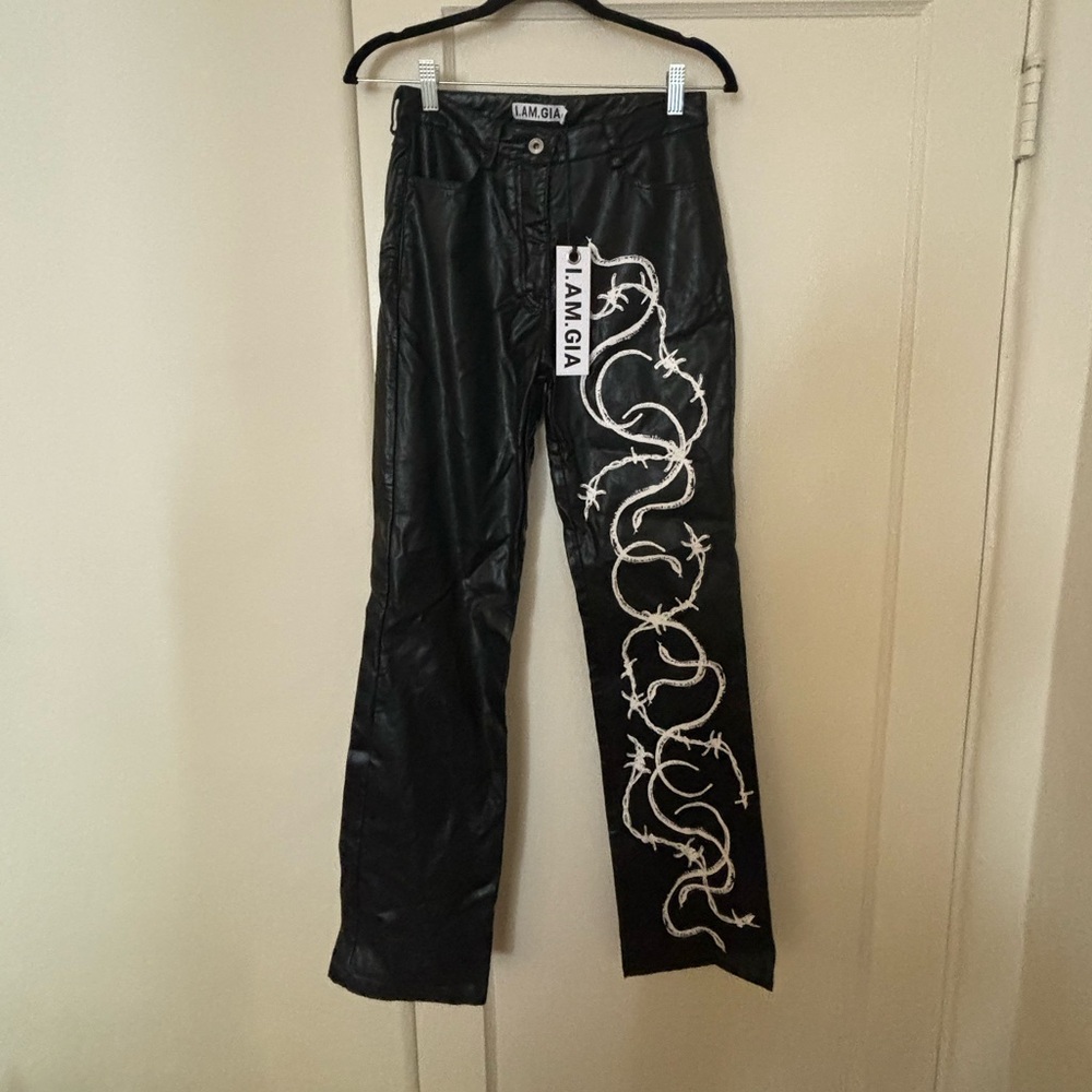 I am Gia black leather pants with white paint lace